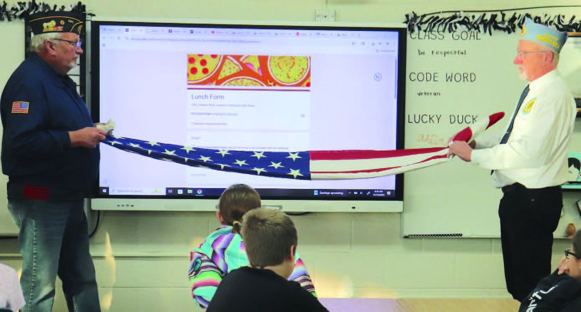 Service organizations present flags to fifth grade students