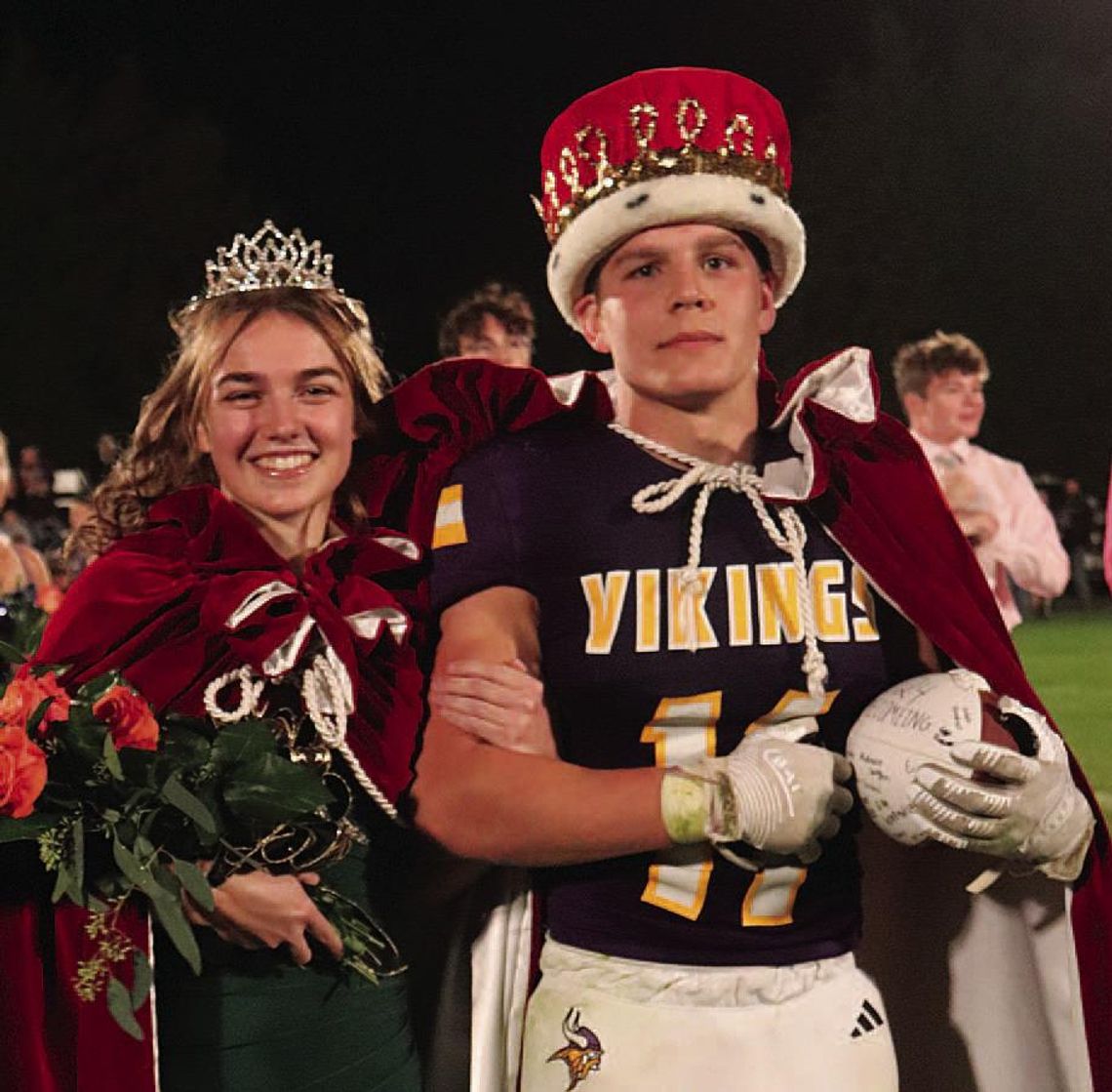 Queen Erin Wagner and King Jaxon Vinson get ready to leave for their ride in a car around the football field